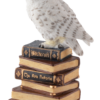 Toversneeuwuil met toverstaf op een boek.